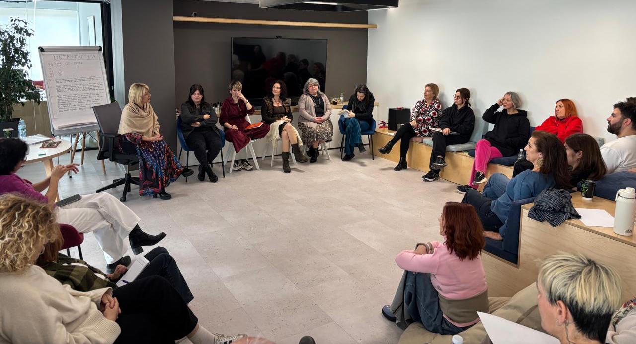 Group of people in a meeting or workshop setting in a modern office space. Systemic Soul Healing anagennisi academy in Athens