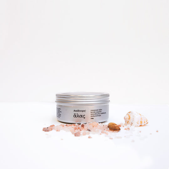 Natural energy salt scrub by ANAGENNISI with sea salt crystals and shells on white background