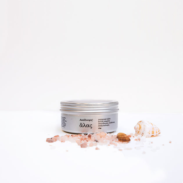 Natural energy salt scrub by ANAGENNISI with sea salt crystals and shells on white background